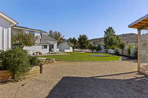 Fenced backyard featuring a patio and a mountain view