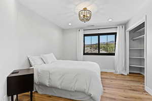 Bedroom featuring light wood-type flooring, recessed lighting, and a chandelier