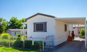 View of front of property with an attached carport