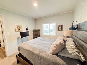 STAGED Bedroom featuring ornamental molding and carpet floors