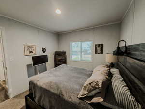 STAGED Carpeted bedroom with crown molding and recessed lighting