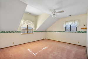 Bonus room featuring vaulted ceiling, carpet floors, and ceiling fan