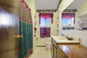 Bathroom with a shower with curtain and vanity