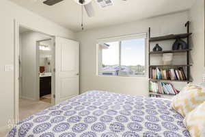 Bedroom featuring light colored carpet and ceiling fan