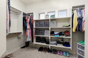 Primary Closet. Spacious closet featuring light colored carpet