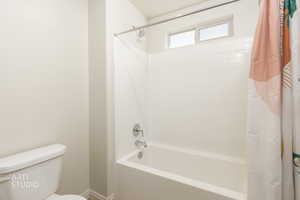 Full bathroom featuring shower / bath combo with shower curtain