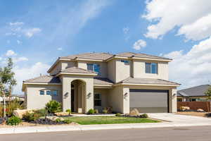 View of front of property featuring stucco siding, a garage, driveway, and a tiled roof