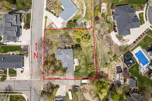Aerial perspective of suburban area featuring a pool area and property boundaries highlighted