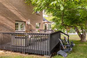 Wooden terrace featuring a yard
