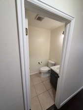 Half bath featuring light tile patterned floors and vanity