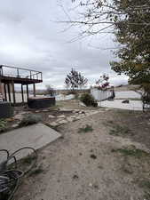 View of yard with a hot tub and an outdoor structure