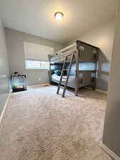 Unfurnished bedroom with light carpet and a textured ceiling