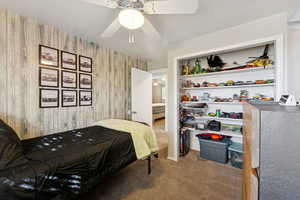 Carpeted bedroom featuring ceiling fan