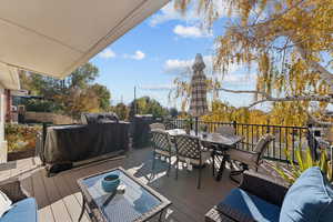 Wooden terrace featuring outdoor dining space, area for grilling, and an outdoor living space