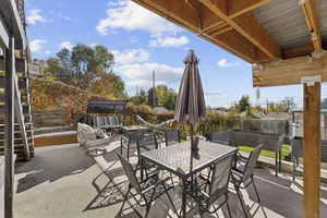 Fenced backyard featuring a patio, outdoor dining area, and an outdoor fire pit