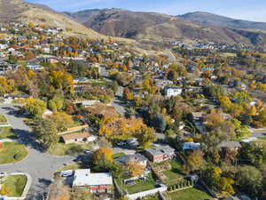 Aerial overview of property's location with nearby suburban area and mountains