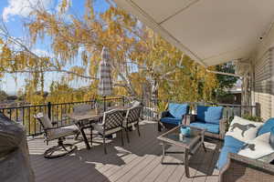 Wooden deck with outdoor dining space and outdoor lounge area