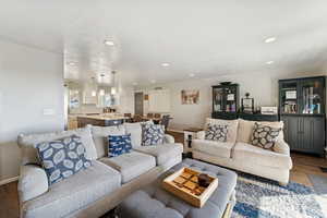 Living area featuring wood finished floors and recessed lighting