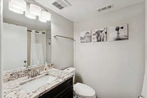 Bathroom featuring vanity and curtained shower