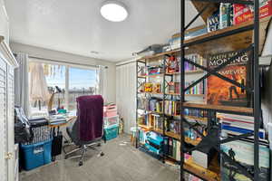 Home office featuring a textured ceiling and carpet floors