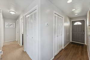 Hallway with baseboards and recessed lighting