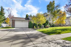Obstructed view of property with driveway, brick siding, and a garage