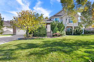 View of front of home featuring brick siding and driveway