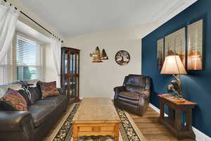 Living room with wood finished floors and baseboards