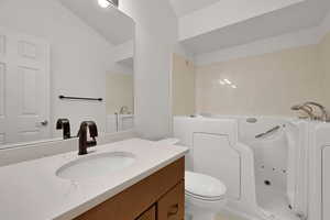 Bathroom featuring a whirlpool tub and vanity