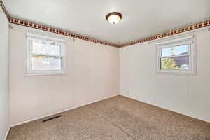 Carpeted room with healthy amount of natural light