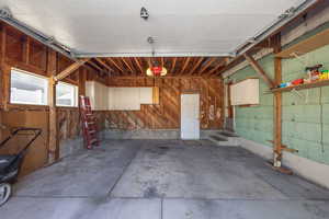 Attached oversized garage featuring a garage door opener