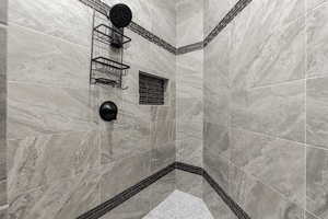 Primary Bathroom featuring a tile shower