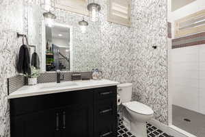 Full bathroom ensuite Office. Featuring vanity and tiled shower