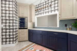 Kitchette/laundry with colored, and cream cabinets