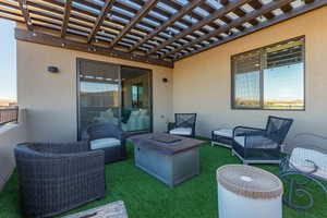 View of patio / terrace with a pergola and a fire pit