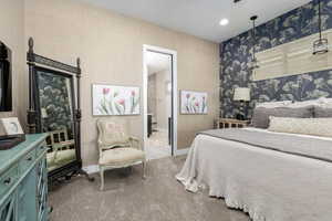 Primary bedroom featuring baseboards and recessed lighting