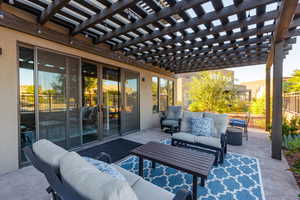 View of patio featuring an outdoor living space and a pergola