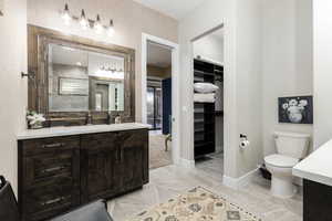 Full Primary bath with vanity and a walk in closet