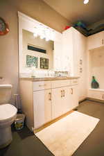 Half bathroom featuring vanity and concrete floors