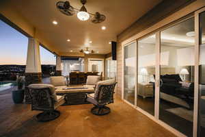 Patio terrace at dusk featuring an outdoor fire pit, a patio, and ceiling fan