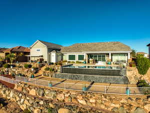 Rear view of house with a patio area and a fenced backyard