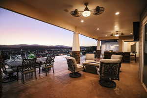 View of patio featuring outdoor dining area, an outdoor fire pit, and a mountain view