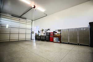 Garage featuring a garage door opener and a workshop area