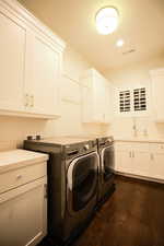 Laundry area featuring cabinet space, dark wood-style floors, independent washer and dryer, and recessed lighting