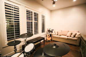 Living area featuring dark wood finished floors, ceiling fan, and recessed lighting
