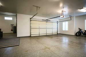 Garage with baseboards and a garage door opener