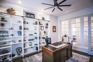 Office space with dark wood-style flooring and ceiling fan