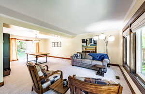 Carpeted living room with ornamental molding