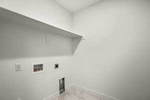 Laundry room with light marble finish flooring, electric dryer hookup, and hookup for a washing machine