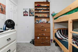 Bedroom 2 with light colored carpet